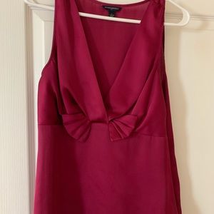 Pink v-neck sleeveless blouse.